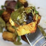 Air-fried pineapple paneer tikka skewer with charred paneer, fresh pineapple, and bell peppers.
