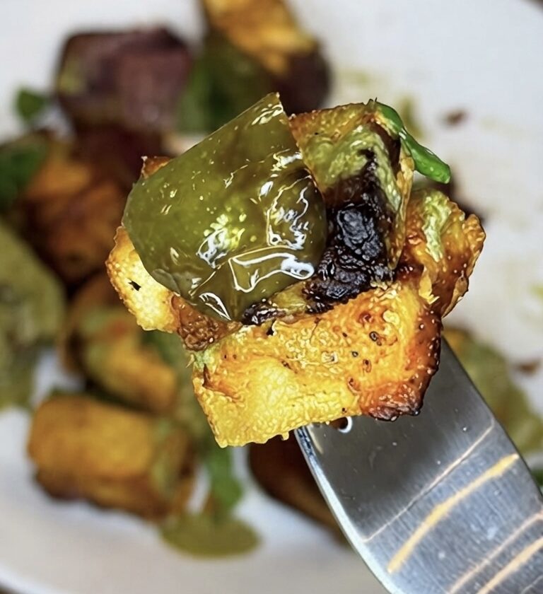 Air-fried pineapple paneer tikka skewer with charred paneer, fresh pineapple, and bell peppers.