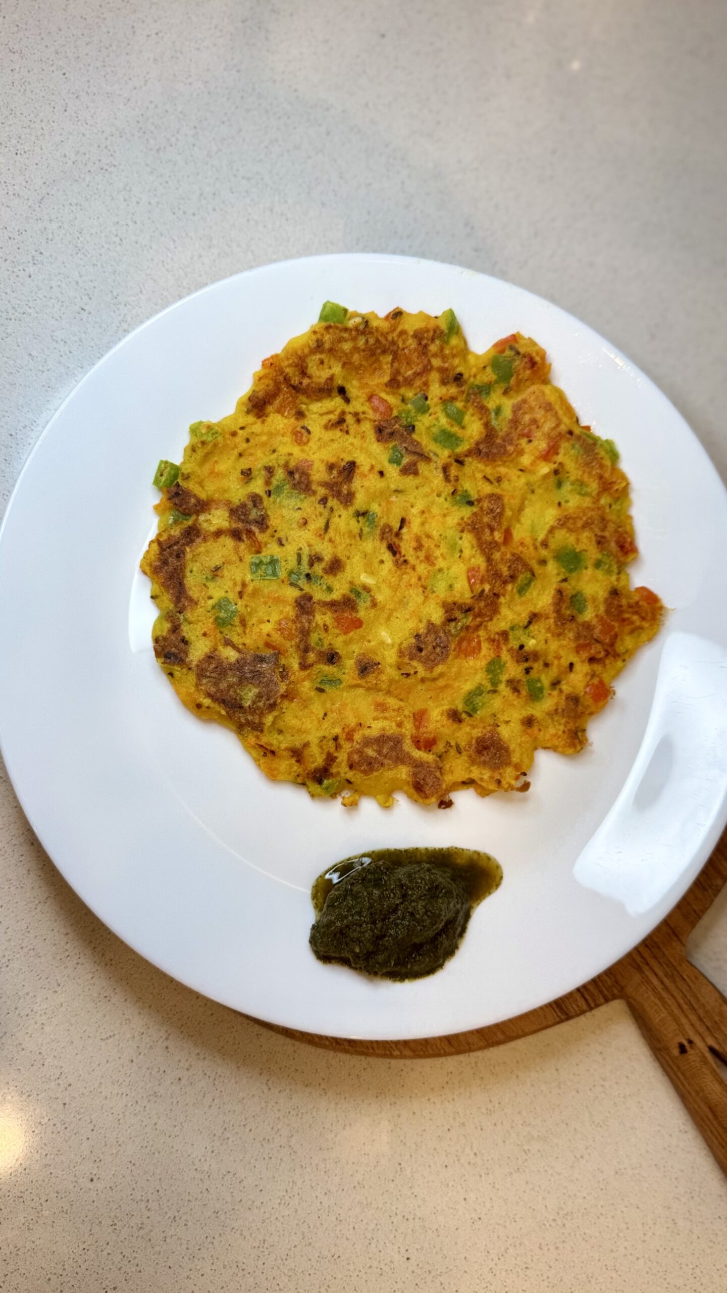 Crispy high-protein street-style moonglet served with fresh green chutney