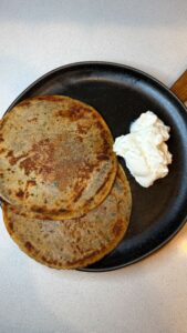 Singhada paneer paratha served with plain yogurt