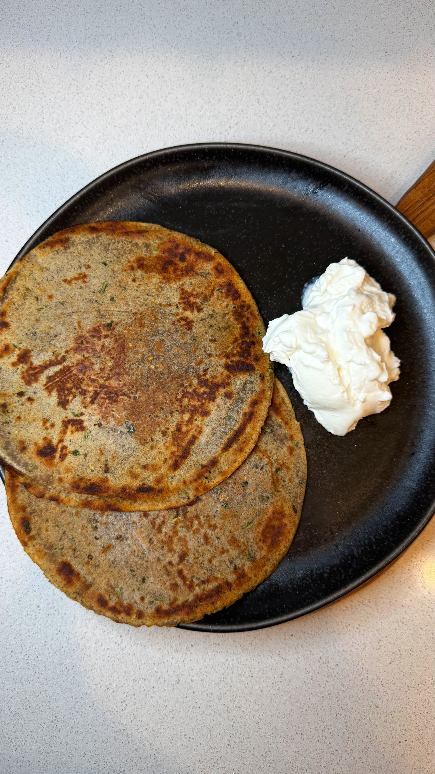 Singhada paneer paratha served with plain yogurt